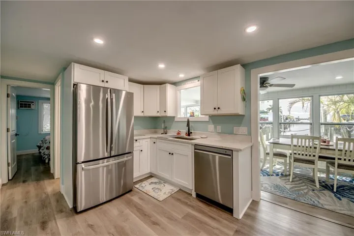 Kitchen featuring appliances with stainless steel finishes, healthy amount of natural light, light wood-type flooring, and recessed lighting