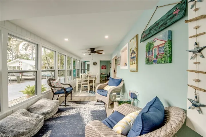 Sunroom with a ceiling fan, outdoor dining space, and an outdoor hangout area