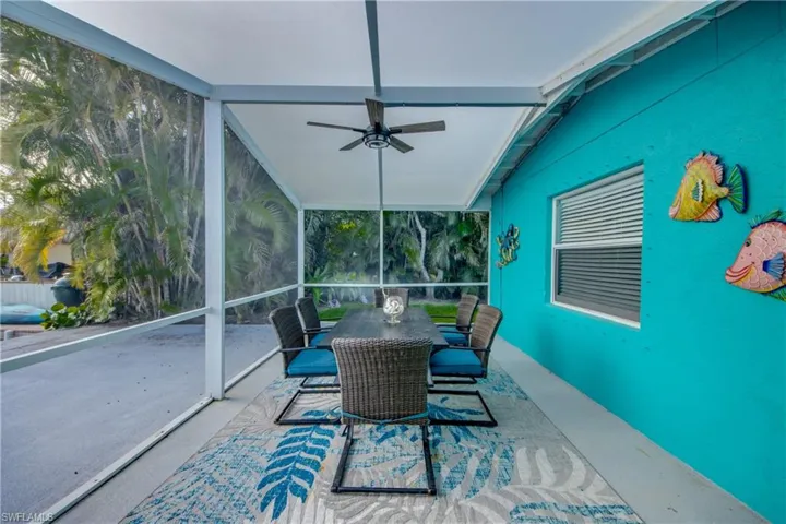 Sunroom featuring outdoor dining area and a ceiling fan
