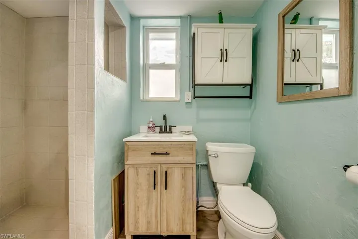 Bathroom featuring vanity and tiled shower