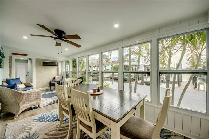 Sunroom with view of canal and dining.