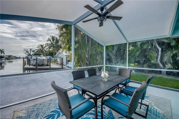 Sunroom / solarium featuring vaulted ceiling, a water view, and healthy amount of natural light
