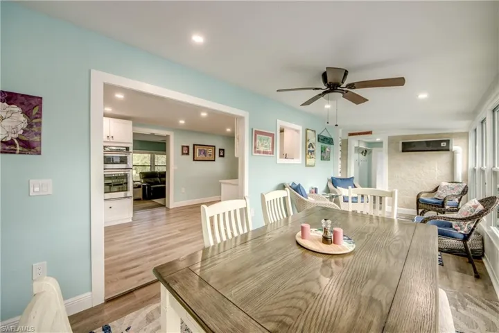 Dining room featuring ceiling fan, light wood-style floors, and recessed lighting