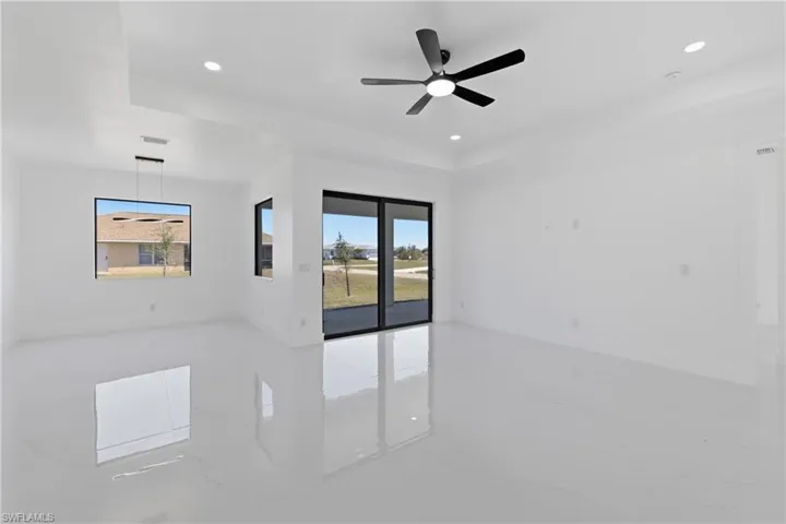 Spare room featuring light marble finish flooring, a ceiling fan, and recessed lighting