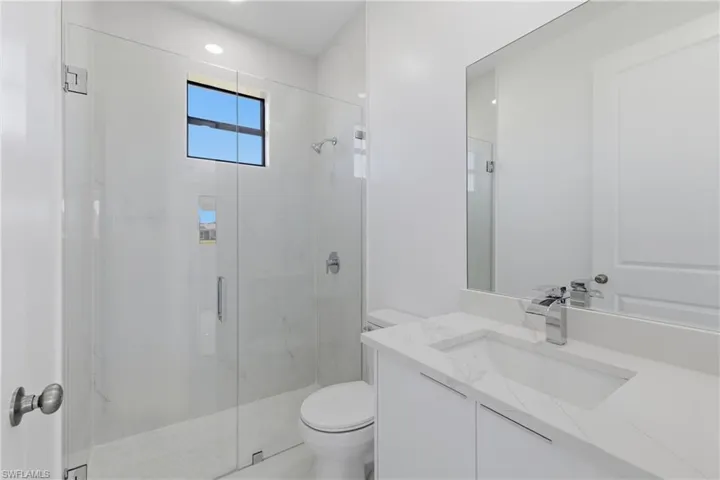 Full bathroom with vanity and a marble finish shower