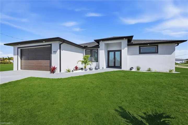 Prairie-style home with a front yard and stucco siding