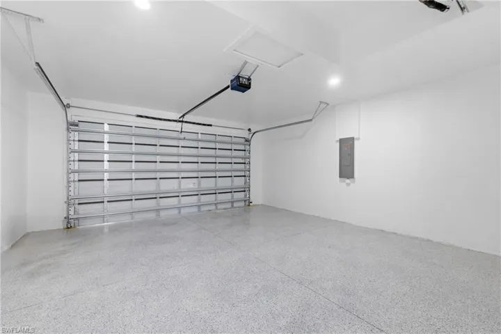 Garage with electric panel and a garage door opener