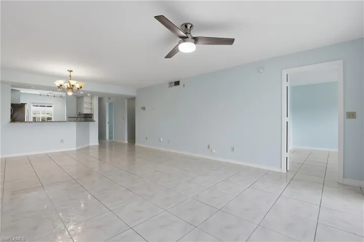 The interior features light-colored walls and flooring, with a ceiling fan providing air circulation