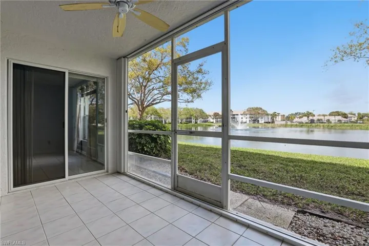 Screened patio featuring tile flooring and a ceiling fan, with sliding glass doors leading to interior spaces