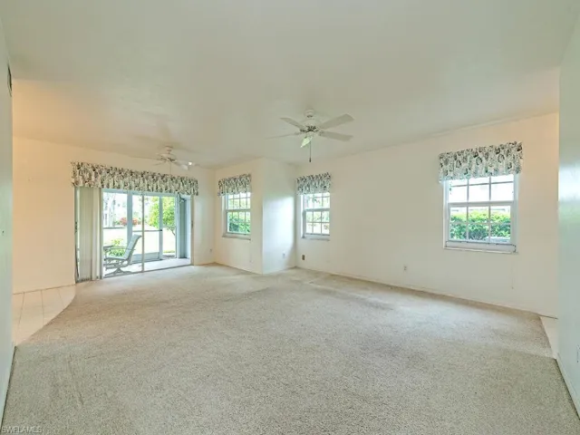 Carpeted empty room with ceiling fan