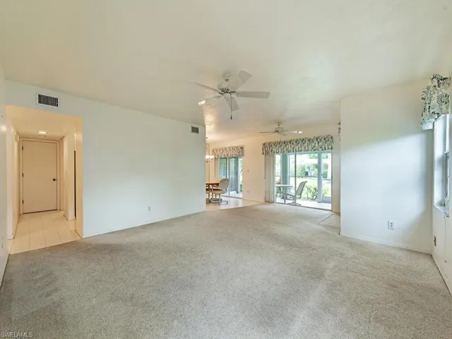 Carpeted spare room with ceiling fan