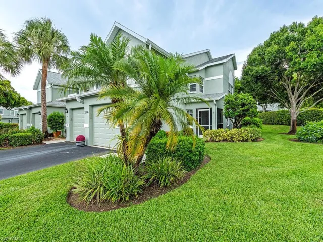 View of front of property with a front lawn and a garage