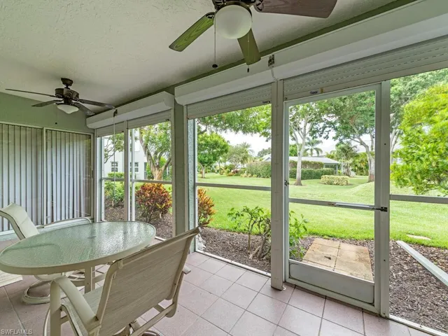 Sunroom / solarium with a wealth of natural light and ceiling fan