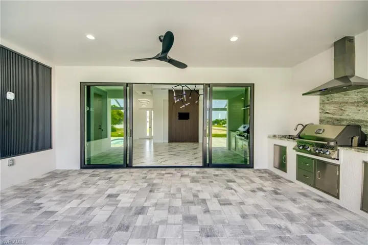 View of terrace with a grill, exterior kitchen, and ceiling fan