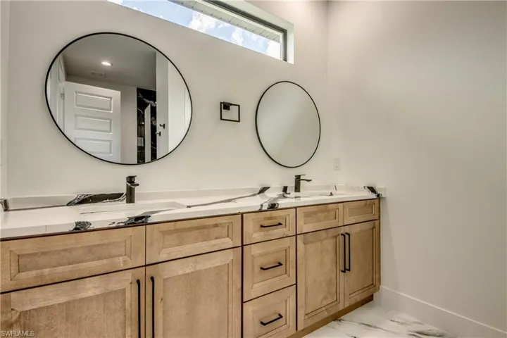 Bathroom with tile floors and dual vanity