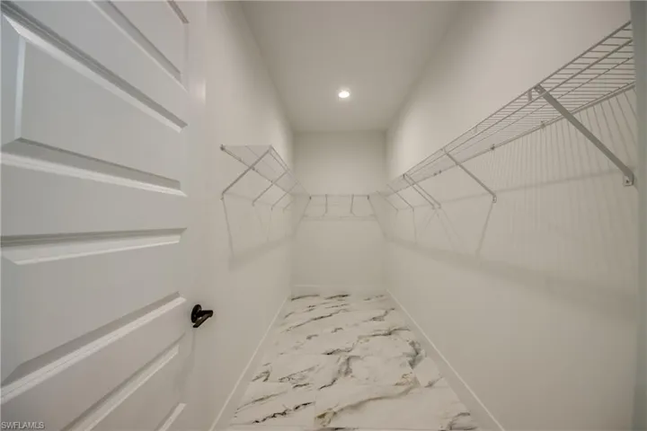 Spacious closet featuring tile floors