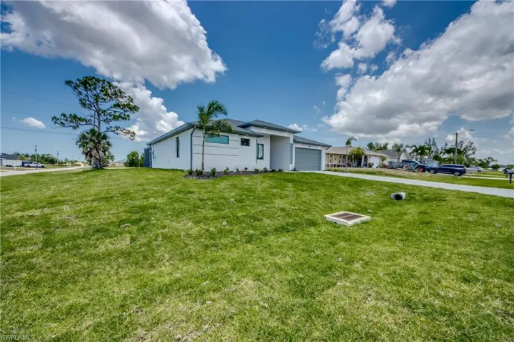Ranch-style house featuring a front yard and a garage