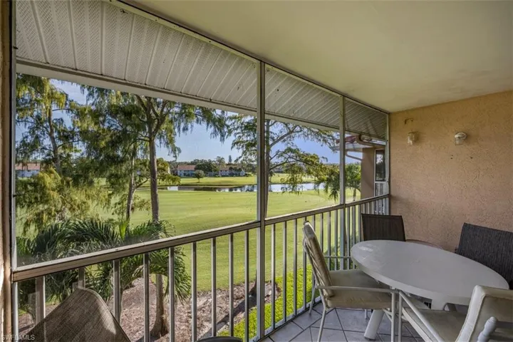 Sunroom / solarium with a water view, a balcony, golf course view, and outdoor dining area