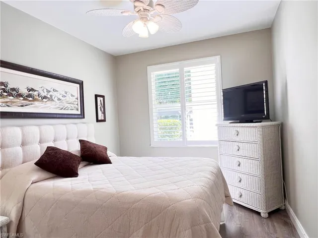 Bedroom with Light Gray Vinyl Flooring and a ceiling fan
