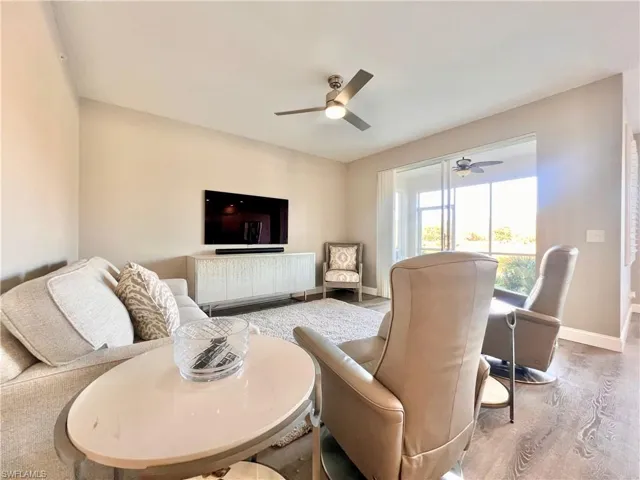 Living area with a ceiling fan & Deluxe light gray vinyl flooring