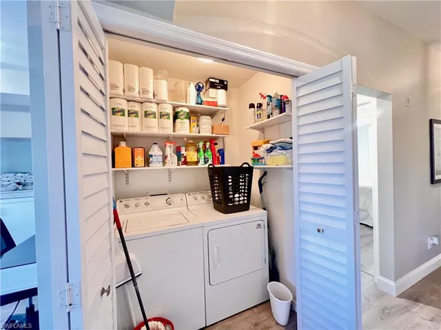 Washroom featuring  Deluxe light gray vinyl flooring & separate washer and dryer