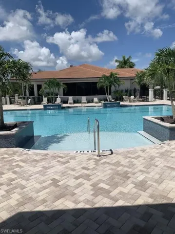 Community pool featuring a patio