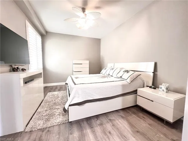 Bedroom with Light Gray Vinyl flooring and a ceiling fan
