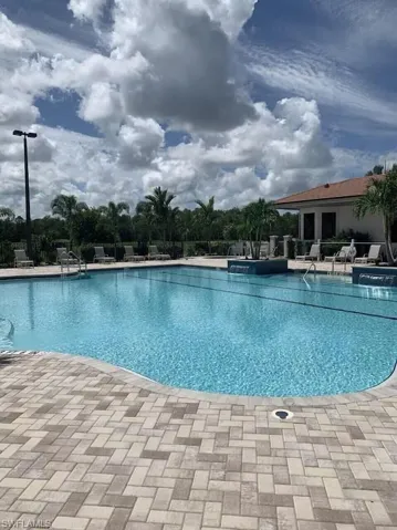 Community pool with a patio