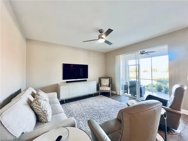 Living area featuring  Deluxe light gray vinyl flooring & ceiling fan