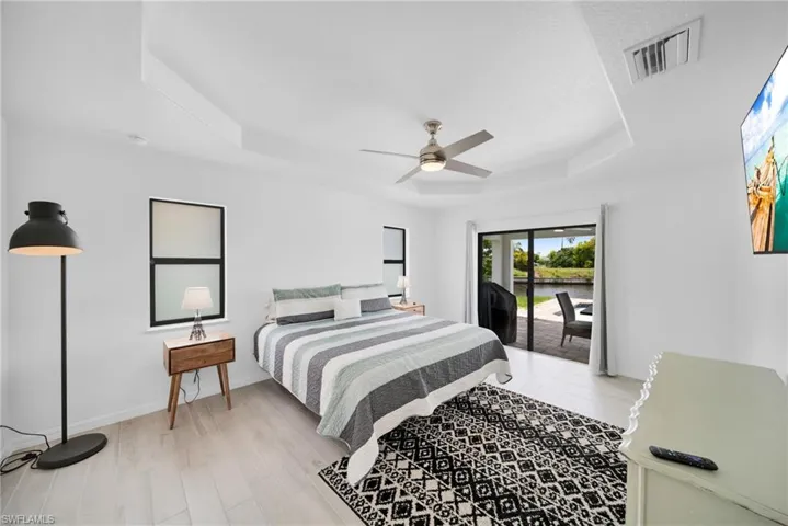 White-painted walls with tray ceiling and a ceiling fan