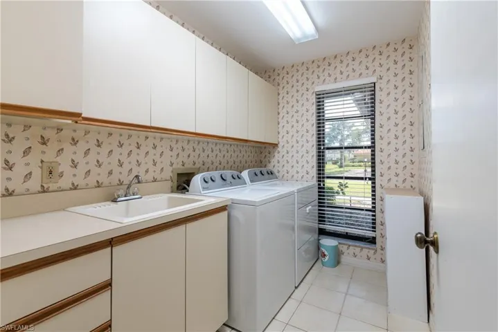 Large laundry room with full size appliances and sink. Pretty view too!!