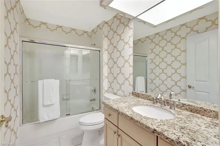 2nd Full bath with granite vanity countertops , combined bath / shower with glass door.