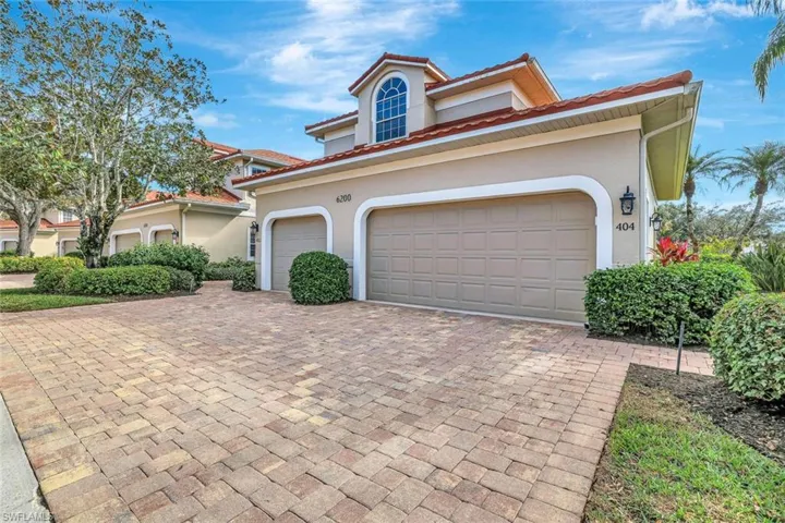 Mediterranean / spanish-style house featuring stucco siding, decorative driveway, a two garage.