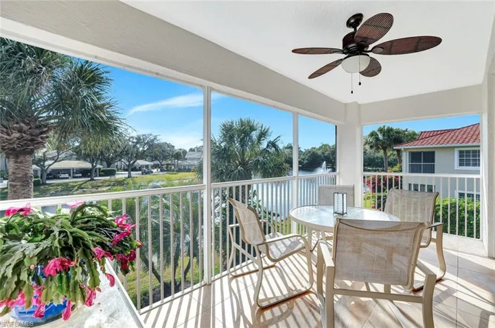 Balcony with lake and fountain view.  Plenty of natural light, and outdoor dining space.
