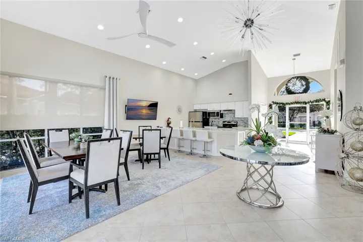 Clubside Reserve's newly decorated clubhouse. Dining space featuring high vaulted ceiling, light tile patterned flooring, recessed lighting, and a ceiling fan.  Kitchen and dining room.  Game room.