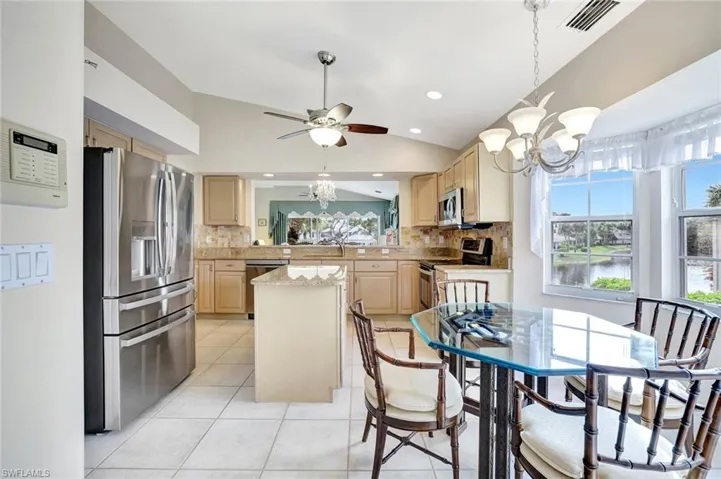 Eat-in kitchen, lofted ceiling, stainless steel appliances, ceiling fan, lake views beaming with natural light.