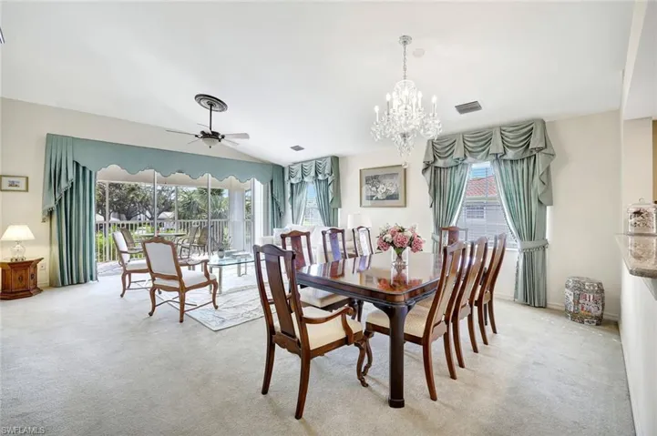 Formal dining area featuring a chandelier and ceiling fan. View of the lake and fountain.