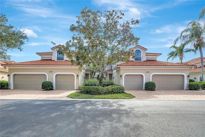 Mediterranean / spanish-style house,  with decorative driveway, and a 2 car garage.