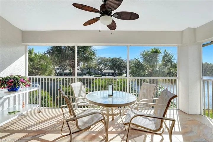 Lanai featuring healthy amount of natural light, a textured wall, and a water view.  Upgraded tiling flooring.