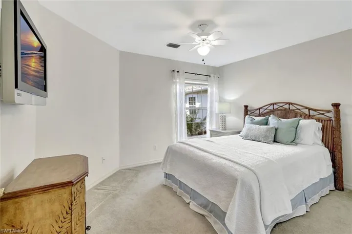 Bedroom featuring ceiling fan and sunlight.