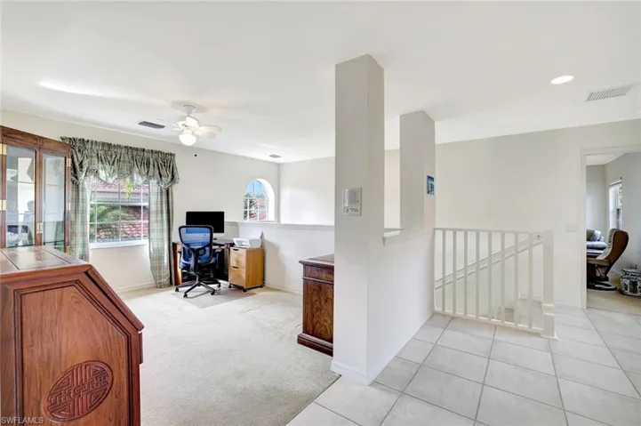Office space or den, featuring ceiling fan and lots of natural light.