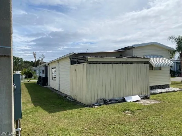 View of side of property featuring a yard
