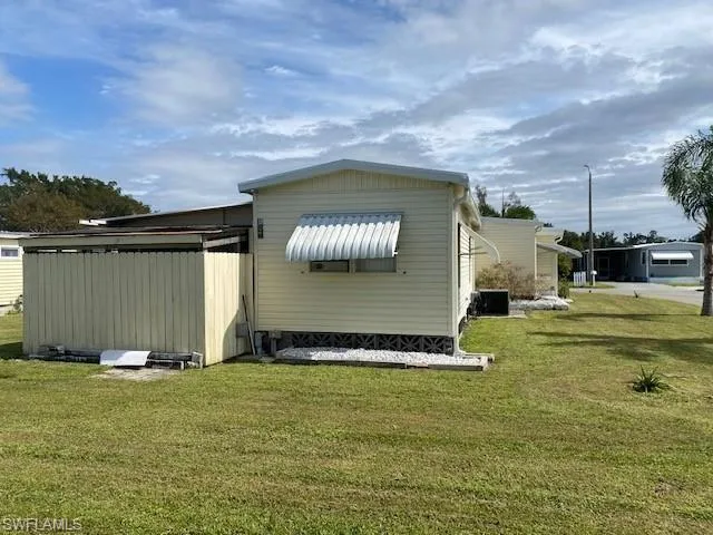 View of home's exterior with a lawn and a central air condition unit