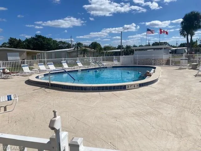 Community pool with a patio