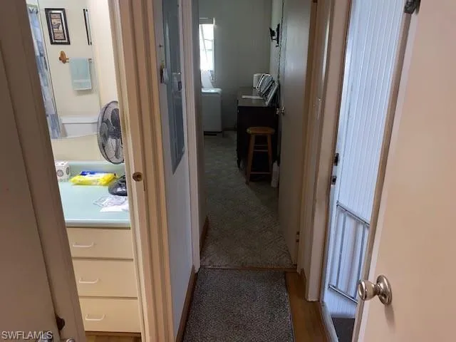 Hallway with carpet flooring