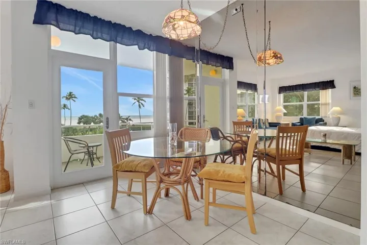Dining area with light tile patterned flooring