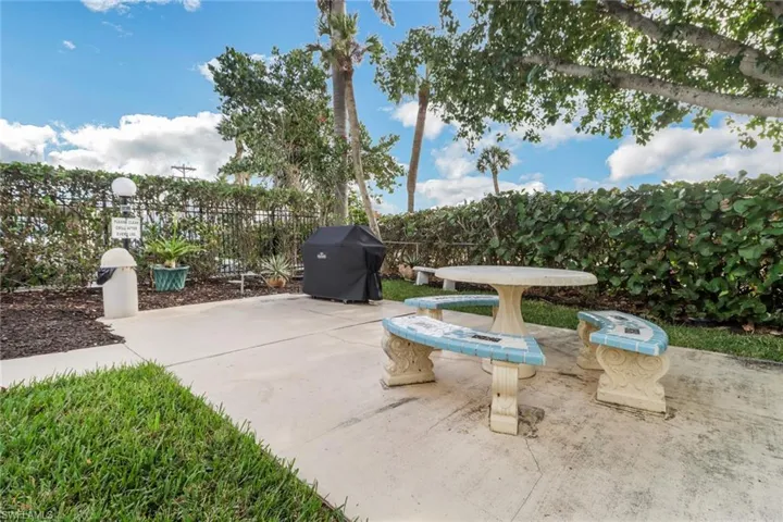 View of patio featuring fence and area for grilling