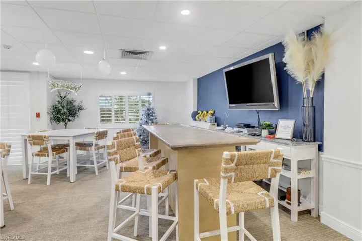 Bar featuring light carpet, a paneled ceiling, and recessed lighting