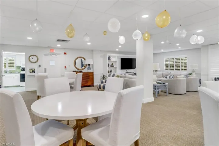 Carpeted dining space with recessed lighting, a drop ceiling, and baseboards