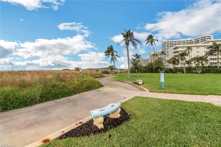 View of property's community featuring a yard